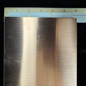 May include: A 6-inch by 6-inch sheet of copper metal with a brushed finish. The copper sheet is a light orange color and has a slight sheen.