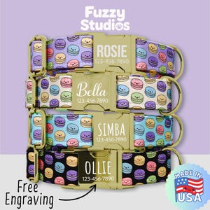 May include: Four pet collars with gold-tone metal buckles featuring engraved names and phone numbers. The fabric straps display a repeating pattern of colorful cartoon macarons. The text Fuzzy Studios and Made in USA are visible.