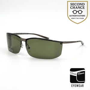 May include: Gucci sunglasses with a dark metal frame and green lenses. The sunglasses have a rectangular shape and the Gucci logo is visible on the left lens. The image includes the text "SECOND CHANCE EYEWEAR".