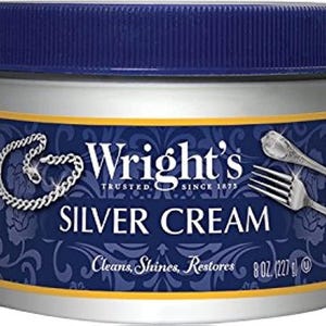 May include: A silver cream container with a blue lid and a silver label. The label features the text "Wright's Silver Cream" and illustrations of silverware and a necklace. The container holds 8 oz (227 g) of silver cream.