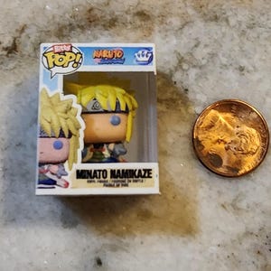 May include: A Funko Pop! vinyl figure of Minato Namikaze from the Naruto anime series. The figure is in its original box, next to a penny for size comparison. The box features the "Pop!" logo and the Naruto logo.