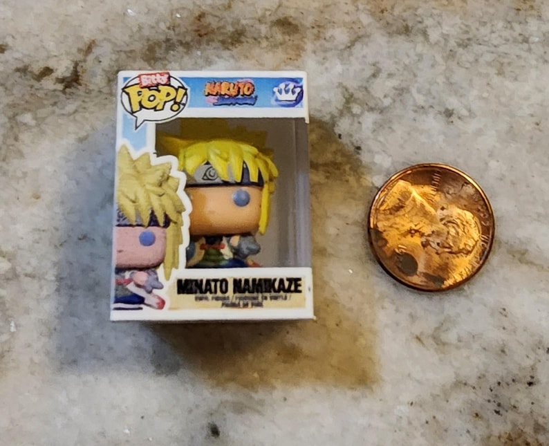 May include: A Funko Pop! vinyl figure of Minato Namikaze from the Naruto anime series. The figure is in its original box, next to a penny for size comparison. The box features the "Pop!" logo and the Naruto logo.