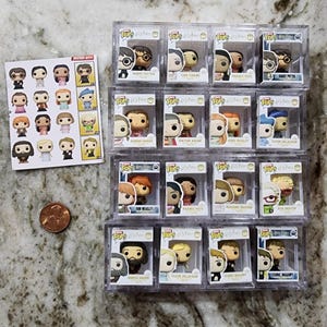May include: A collection of 18 Harry Potter Funko Pop figures in clear plastic boxes. The figures are arranged in three rows of six. The figures include Harry Potter, Ron Weasley, Hermione Granger, Draco Malfoy, Neville Longbottom, Luna Lovegood, Ginny Weasley, Fred Weasley, George Weasley, Percy Weasley, Charlie Weasley, Bill Weasley, Molly Weasley, Arthur Weasley, Albus Dumbledore, Severus Snape, Rubeus Hagrid, and Sirius Black.