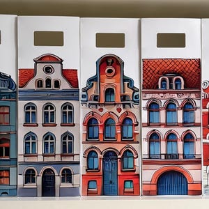 Op de afbeelding: Zes witte opbergdozen met een handgreepuitsparing, elk met een kleurrijke illustratie van een Europese gebouwgevel. De gebouwen hebben gedetailleerde ramen, deuren en architectonische elementen in tinten rood, blauw en oranje.