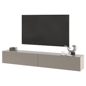 May include: A modern, taupe-colored floating media console with two drawers, a large black screen television mounted above it, and decorative items. The console has a minimalist design, with a smooth, matte finish. Decorative items include a small box and a sculpture.