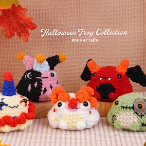 May include: Five crocheted frog figures from the Halloween Frog Collection PDF pattern. The frogs feature various designs including a clown, a jester, a devil with black wings, a colourful party frog, and a green zombie frog with stitched details.