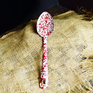 May include: A set of three ceramic mugs with a speckled, matte finish. The mugs are in shades of cream, light gray, and dark gray. Each mug has a simple, minimalist design and a rounded handle.