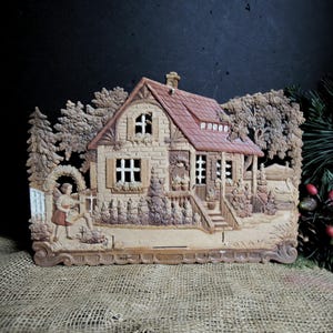 Calendario navideño antiguo de papel prensado grande troquelado alemán de 12,5" x 9" con publicidad en relieve, casa de papel, niña, cisnes y árboles, fabricado en Alemania