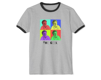 May include: A grey ringer t-shirt with a black collar and sleeves. The shirt displays a pop art design of a person in four coloured squares. The text "THE GEEK" is printed below the squares.