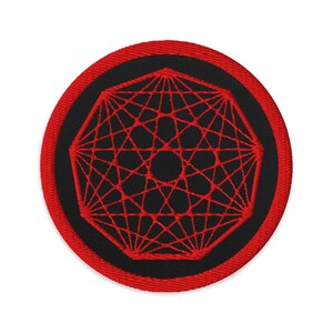 May include: Circular embroidered patch with a geometric red design on a black background. The patch has a red border. The design is a complex network of lines radiating from a central point. The patch is circular.