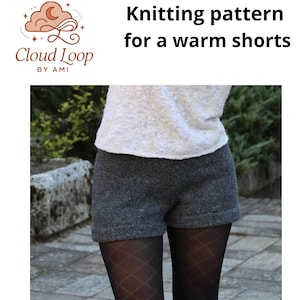 May include: Image of a knitting pattern for warm shorts. The shorts are a dark gray color and appear to be made of a thick knit material. The model is wearing a light-colored top. The text "Knitting pattern for a warm shorts" is displayed.