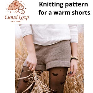 May include: The image displays a knitted shorts pattern. The shorts are a warm brown color and are cuffed at the hem. The model is wearing a white sweater and black tights with a bat pattern. The text reads "Knitting pattern for a warm shorts."