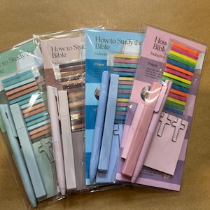 May include: Packaged Bible study kits with pens, sticky notes, and paper clips. Each kit includes a booklet titled "How to Study the Bible" in various colors, including blue, pink, and green. The kits also contain colorful sticky flags.