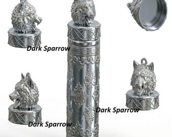 May include: A silver container with a wolf head lid, featuring an embossed floral pattern. The text "Dark Sparrow" is visible. The image shows the container from several angles, highlighting its design.