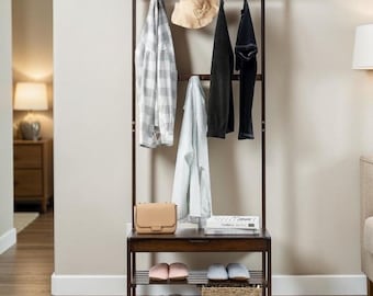May include: A dark brown wooden hall tree with a bench, shoe rack, and hanging rack. A beige purse, a straw hat, and several articles of clothing hang from the rack. The shoe rack holds slippers and a woven basket.