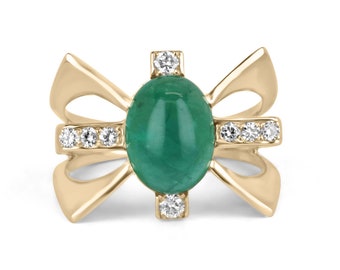 May include: A gold ring featuring a large green emerald gemstone and smaller diamonds set in a bow-shaped design.
