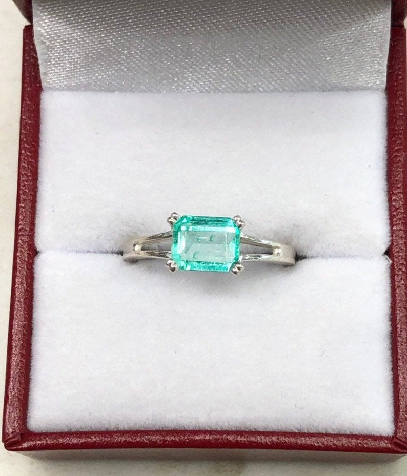 Zambian Elegance: 1.25 Carat Emerald Solitaire Silver Engagement Ring