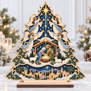 May include: A multi-layered wooden Christmas tree decoration featuring a nativity scene at the centre with a manger, figures, and sheep. Above, four angels play trumpets against a dark blue starry sky. A townscape is depicted at the base.