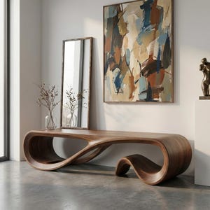 May include: A long, low-profile wooden console table featuring a continuous, fluid, wave-like design with a smooth, dark brown wood grain finish. The piece has an open, sculptural form that curves to create two distinct, hollow base sections.