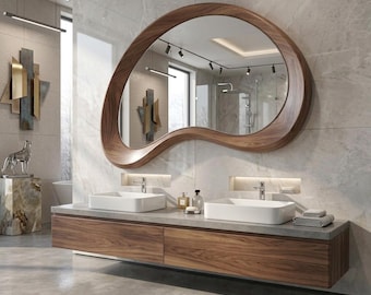 May include: A wall-mounted bathroom vanity featuring a dark wood grain finish with two white rectangular vessel sinks and a large, organic-shaped mirror with a matching dark wood frame, all set against a light gray marble-tiled wall.