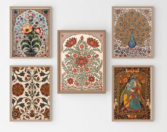 May include: Five framed art prints with Indian-inspired designs. The prints feature floral arrangements, a peacock, and a couple in traditional attire. The colour palette includes reds, blues, and golds, with intricate patterns and details.