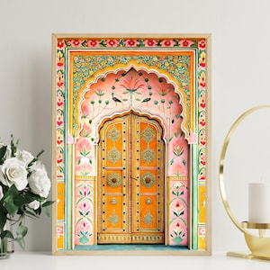 May include: A framed print depicting an elaborately decorated doorway. The door is a bright orange with gold detailing, framed by a pink and green floral arch. The artwork showcases intricate patterns and a warm colour scheme, suggesting cultural heritage.