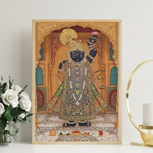 May include: A framed painting depicting a deity in traditional Indian dress. The artwork shows a dark-skinned figure wearing detailed jewellery and holding a lotus flower. The background features ornate architectural details and a patterned floor.
