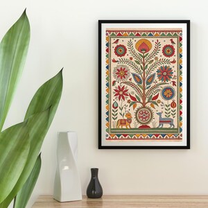 May include: A framed, colorful folk art print featuring a tree with flowers, birds, and animals. The artwork has a cream-colored background and a black frame. The tree is the central focus, with red, blue, and yellow flowers.