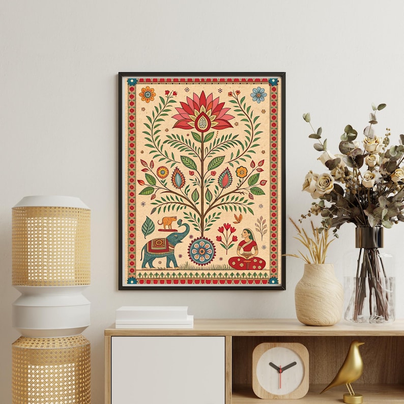 May include: A framed art print featuring a stylized tree with a large red flower at the top. The artwork includes an elephant, a woman, and other decorative elements in shades of green, blue, red, and yellow against a beige background.