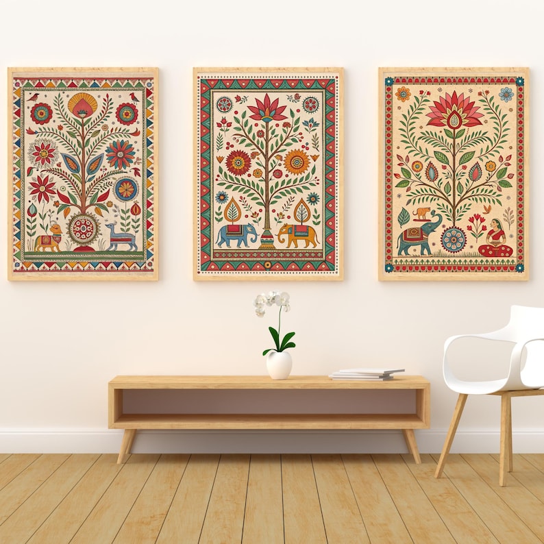 May include: Three framed art prints with colorful, intricate tree and animal designs. The artwork features a cream background with red, blue, yellow, and green details. The frames are a light wood color, and the overall style is reminiscent of traditional Indian art.