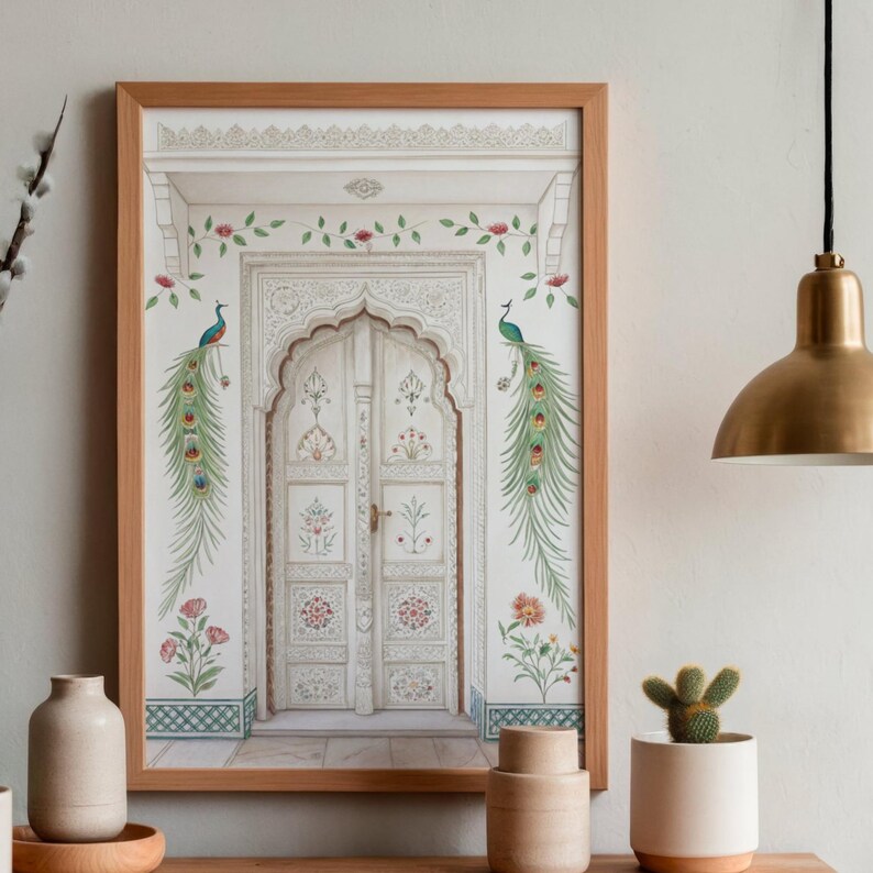 May include: A framed print featuring a detailed illustration of a white arched doorway with intricate carvings. Two peacocks with long, colorful tail feathers flank the door. Floral and vine accents in pink and green adorn the frame, creating an elegant aesthetic.