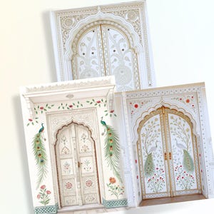 May include: Three decorative cards featuring ornate door designs. The doors are white with gold accents and intricate patterns. Some cards include peacock illustrations and floral details, creating an elegant and artistic aesthetic.