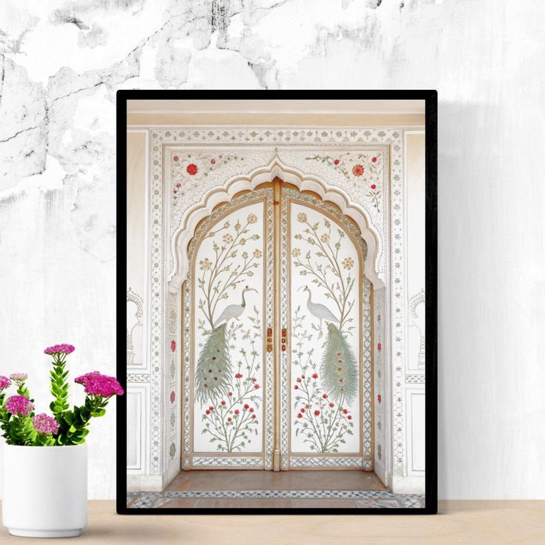 May include: Framed art print featuring a detailed illustration of a white arched doorway with gold trim. The doors are adorned with peacocks, floral patterns, and red flowers. The artwork is set against a white marble background.