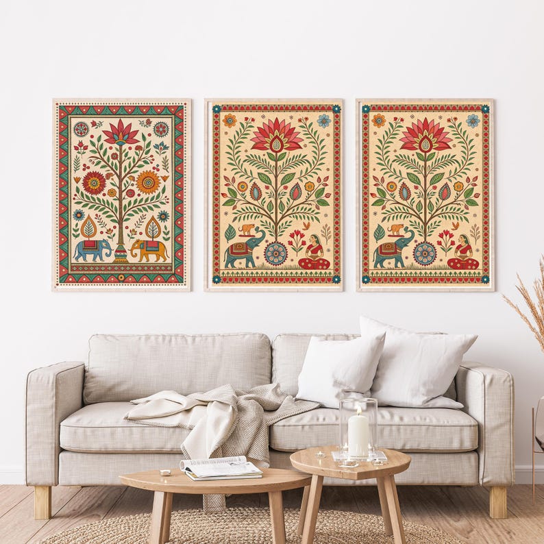 May include: Three framed art prints featuring colorful, stylized depictions of trees, elephants, and floral patterns. The artwork has a cream-colored background with red, green, blue, and yellow accents. The prints are displayed above a beige sofa.