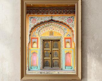 May include: A framed print of an ornate, arched doorway. The door is wooden with intricate carvings, set within a vibrant, multi-colored facade. The color palette includes shades of yellow, orange, pink, and turquoise, creating a visually rich and detailed architectural image.