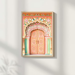 May include: A framed print featuring a detailed, ornate archway and door. The archway is pink with floral and leaf patterns in pink, green, and white. The door is a soft pink with tree designs. The frame is a light wood colour.
