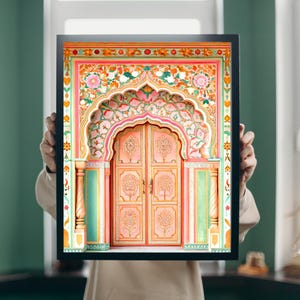May include: A framed print depicting a colourful, ornate archway and double doors. The artwork uses pinks, greens, and oranges, with detailed floral and geometric patterns. The doors feature tree designs. The frame is black.