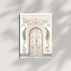 May include: A watercolor print of a white arched doorway with intricate carvings and floral details. The artwork features peacock feather accents and floral patterns, with a decorative border at the base. The overall theme is an Indian architectural design.