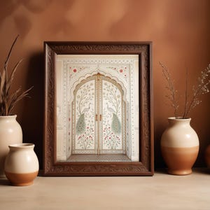 May include: A framed print of ornate doors with peacock illustrations. The doors are white with floral and peacock designs, set within an arched frame. The frame is dark brown, and the background is a warm brown. Vases are in the foreground.