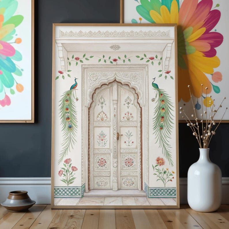 May include: A framed print featuring a detailed illustration of a white arched doorway with intricate carvings and floral accents. Two peacocks are perched on the wall, and the artwork is set against a light background with a wooden floor.