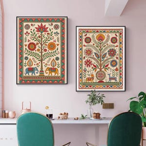 May include: Two framed art prints featuring colorful tree of life designs. Each print showcases a central tree with flowers, leaves, and animals like elephants and deer. The artwork is framed with a decorative border in red, green, and yellow.