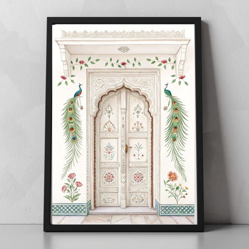 May include: A framed art print featuring a white arched doorway with intricate carvings. The artwork includes colorful floral and peacock feather accents, with two peacocks perched on the wall. The print is set against a white wall with a black frame.