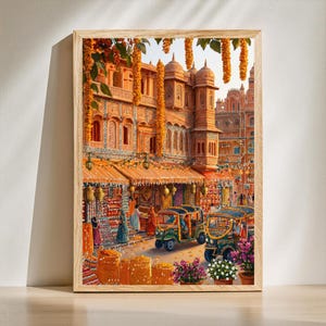 Pode incluir: Impressão emoldurada retratando uma vibrante cena de rua indiana. A obra de arte apresenta edifícios ornamentados, têxteis coloridos e riquexós. A cena é adornada com grinaldas florais laranja e plantas em vasos.