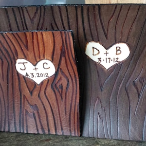 May include: Two wooden plaques with carved hearts and initials. The first plaque has the initials "J + C" and the date "4.3.2012". The second plaque has the initials "D + B" and the date "3.17.12".