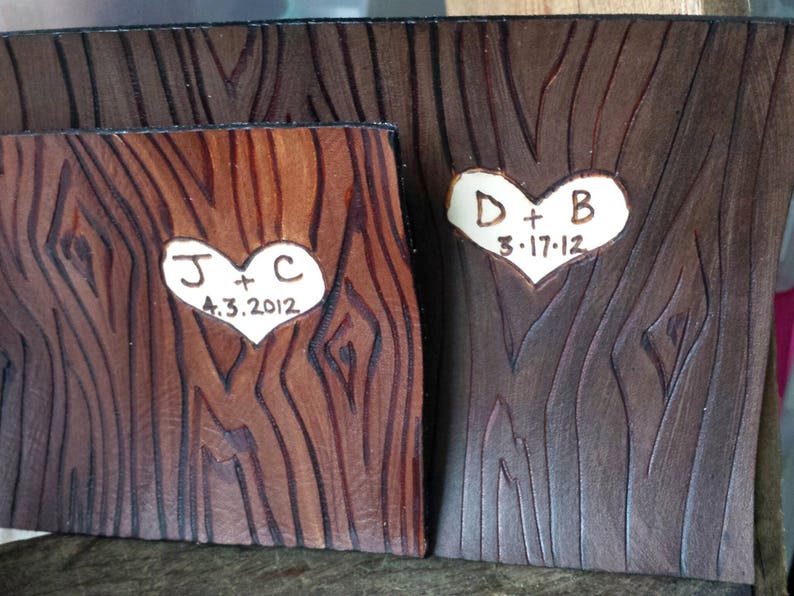 May include: Two wooden plaques with carved hearts and initials. The first plaque has the initials "J + C" and the date "4.3.2012". The second plaque has the initials "D + B" and the date "3.17.12".