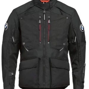 May include: A black motorcycle jacket featuring a high collar, a central zipper, and multiple pockets with red-accented zipper pulls. The sleeves and chest display the circular blue and white BMW logo. The jacket includes adjustable straps.