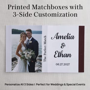May include: A rectangular matchbox featuring a photograph of a couple on the left side, the text The Perfect Match on the center spine, and the names Amelia & Ethan with the date 06.27.2027 printed in black on a white background on the right.