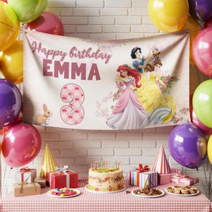 May include: A birthday party scene with a banner that reads "Happy birthday EMMA" and a large number "3". The banner features Disney princesses. The table is set with gifts, a cake, and party hats, surrounded by colorful balloons.