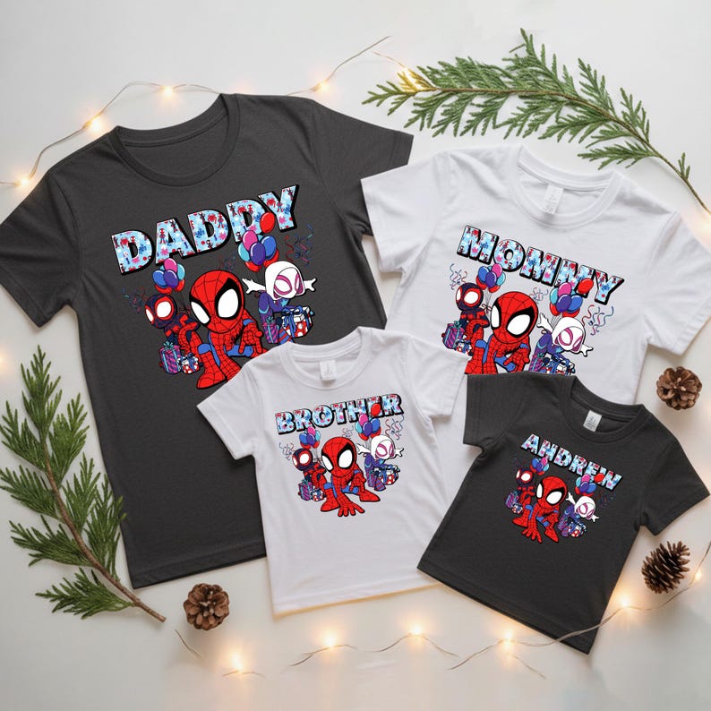 Puede incluir: Un conjunto de camisetas a juego con gr&aacute;ficos de Spider-Man y Spider-Gwen. Las camisetas son negras, blancas y grises, con texto que dice "DADDY", "MOMMY", "BROTHER" y "ANDREW". Tambi&eacute;n se incluyen globos y cajas de regalo festivos.