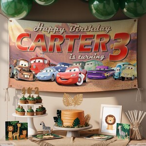 May include: A birthday party scene with a banner that reads "Happy Birthday CARTER 3 is turning." The banner features cartoon cars. There are cupcakes, a cake, and animal-themed decorations. Green balloons are at the top.